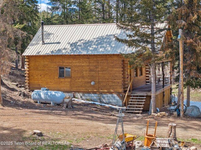 2 Porcupine Cir, Dubois, WY 82513 - view of home's exterior featuring log siding, stairs, and a metal roof