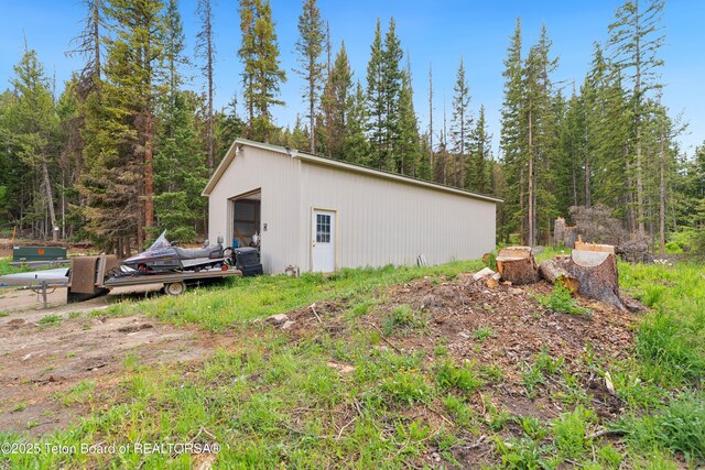 2 Porcupine Cir, Dubois, WY 82513 - view of side of home featuring an outbuilding and a wooded view