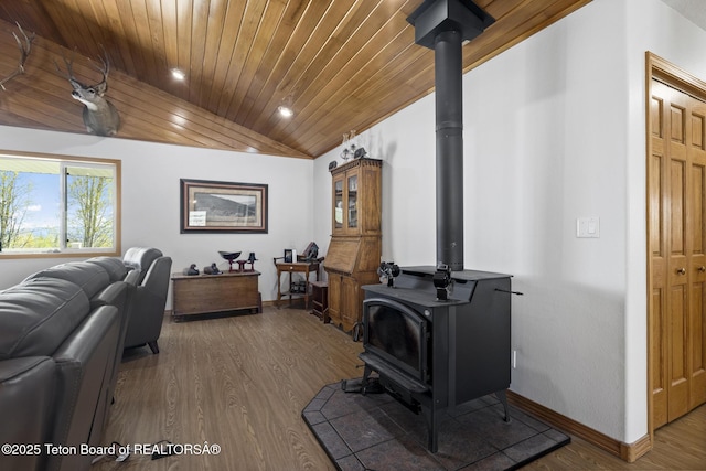 51 Buckaroo Cir, Etna, WY 83118 - living room with a wood stove, baseboards, wood finished floors, wood ceiling, and vaulted ceiling