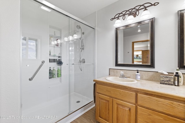 51 Buckaroo Cir, Etna, WY 83118 - bathroom with a shower stall, vanity, and wood finished floors