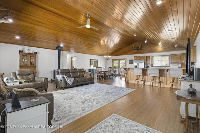 51 Buckaroo Cir, Etna, WY 83118 - living room with a wood stove, wooden ceiling, vaulted ceiling, ceiling fan, and dark wood finished floors