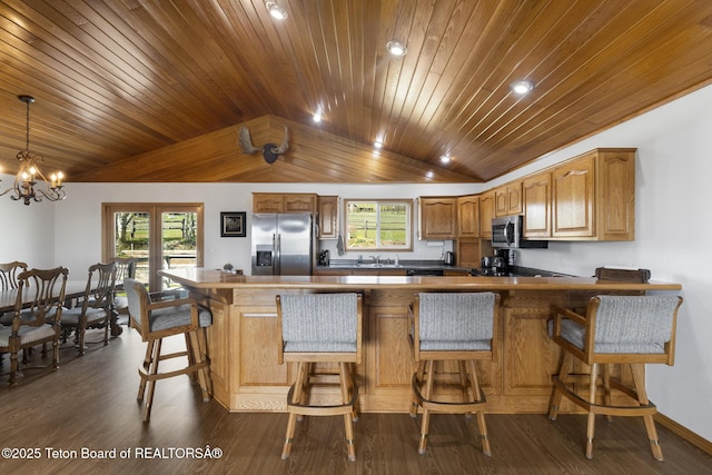 51 Buckaroo Cir, Etna, WY 83118 - kitchen with appliances with stainless steel finishes, wood ceiling, a peninsula, a sink, and dark wood-style floors