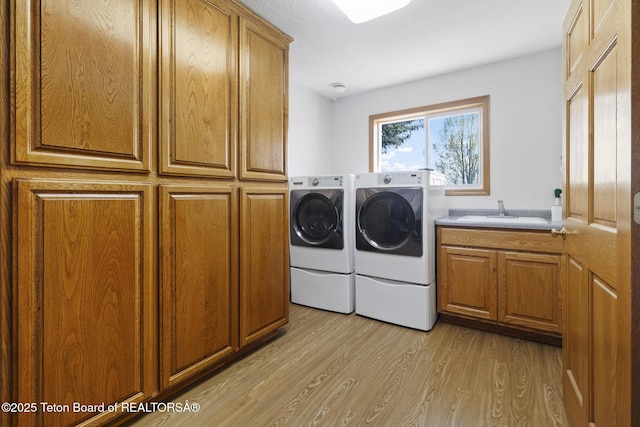 51 Buckaroo Cir, Etna, WY 83118 - clothes washing area with independent washer and dryer, cabinet space, and light wood finished floors