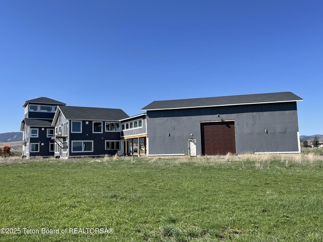 5860 Bitter Creek Rd, Afton, WY 83110 - back of house featuring a garage and a yard