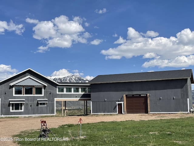 5860 Bitter Creek Rd, Afton, WY 83110 - rear view of house featuring a garage, a yard, and dirt driveway