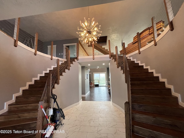 5860 Bitter Creek Rd, Afton, WY 83110 - stairs with a towering ceiling, a chandelier, and baseboards