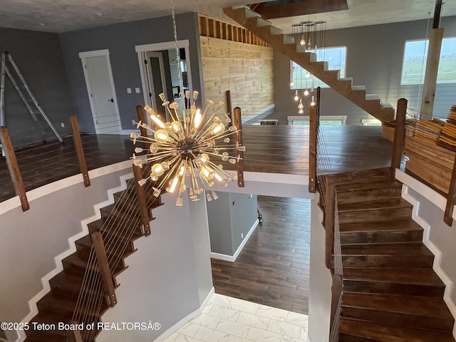 5860 Bitter Creek Rd, Afton, WY 83110 - stairway featuring a chandelier and baseboards