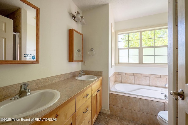 99 Sugar Lf, Star Valley Ranch, WY 83127 - full bathroom with a bath, double vanity, a shower with shower door, toilet, and tile patterned flooring