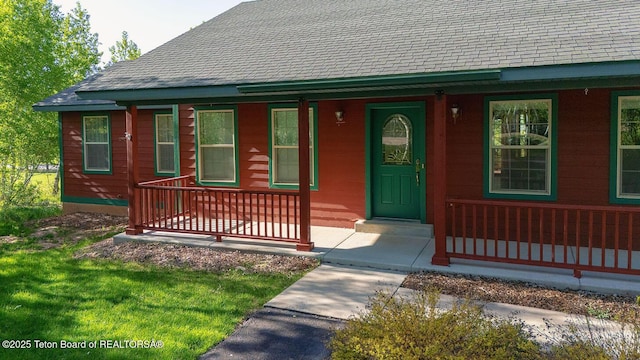 99 Sugar Lf, Star Valley Ranch, WY 83127 - doorway to property featuring covered porch and roof with shingles