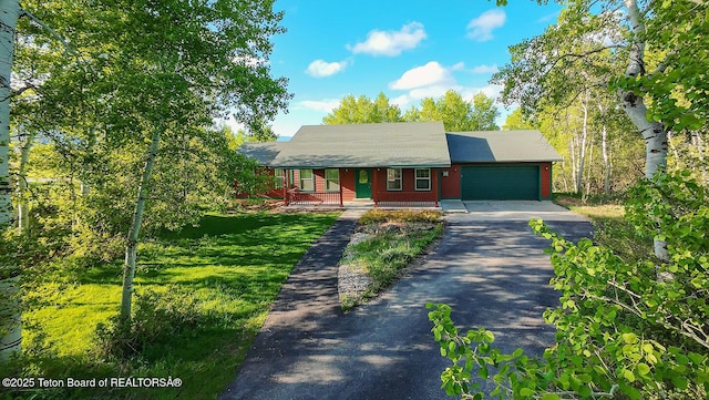 99 Sugar Lf, Star Valley Ranch, WY 83127 - view of front of house with asphalt driveway, a porch, and a garage
