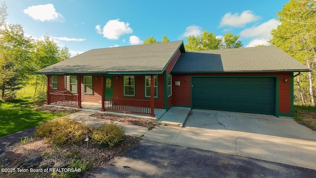 99 Sugar Lf, Star Valley Ranch, WY 83127 - view of front of home with an attached garage, a porch, and concrete driveway