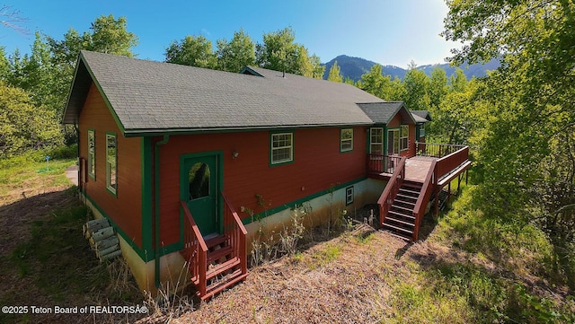 99 Sugar Lf, Star Valley Ranch, WY 83127 - rear view of house with stairs, entry steps, a deck with mountain view, and a shingled roof