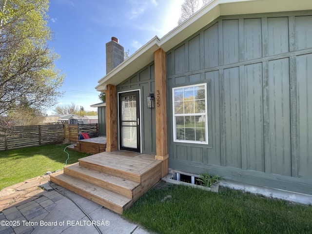 325 1st St N, Cokeville, WY 83114 - property entrance with board and batten siding and a chimney