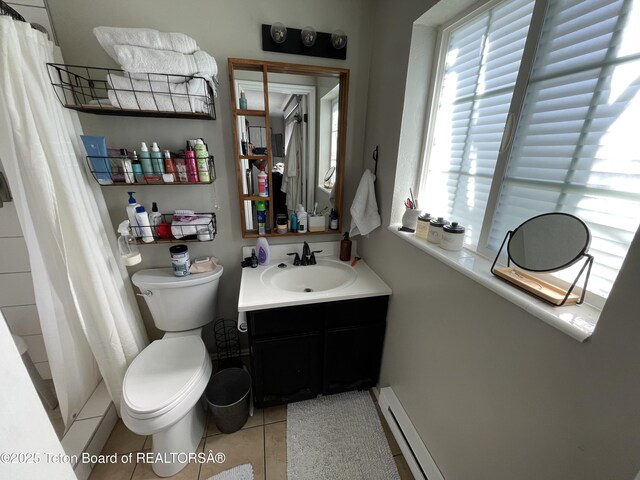 325 1st St N, Cokeville, WY 83114 - bathroom with toilet, tile patterned floors, vanity, curtained shower, and a baseboard radiator