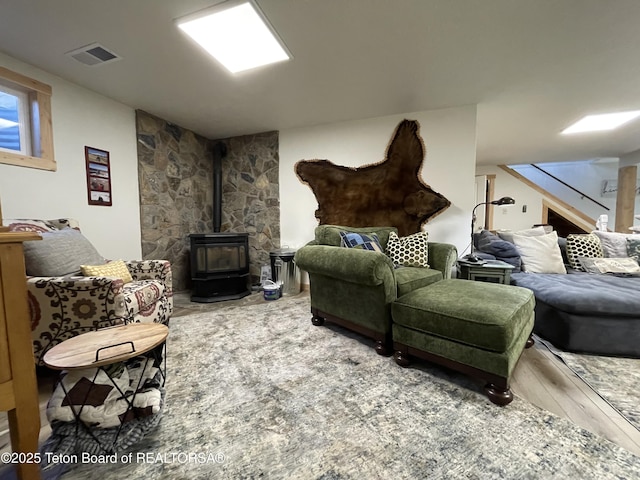 325 1st St N, Cokeville, WY 83114 - living room with a wood stove, wood finished floors, and stairway