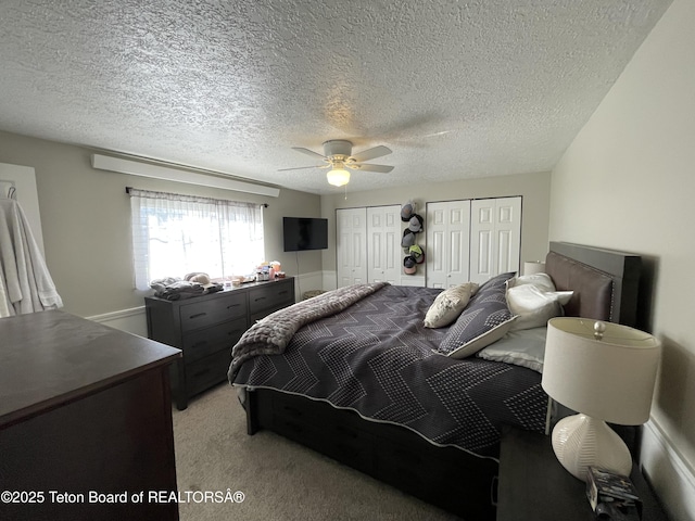 325 1st St N, Cokeville, WY 83114 - bedroom with multiple closets, light colored carpet, ceiling fan, and a textured ceiling