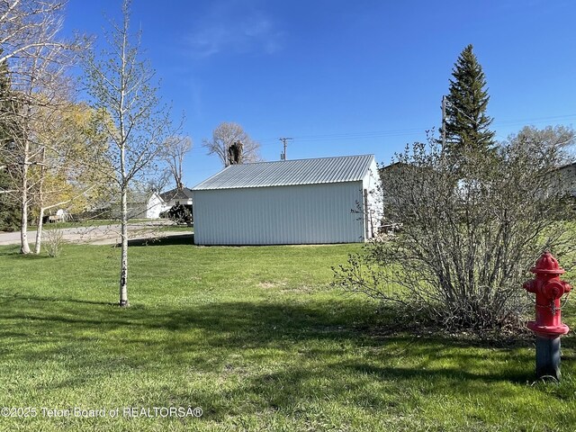 325 1st St N, Cokeville, WY 83114 - view of grassy yard featuring an outdoor structure and a pole building