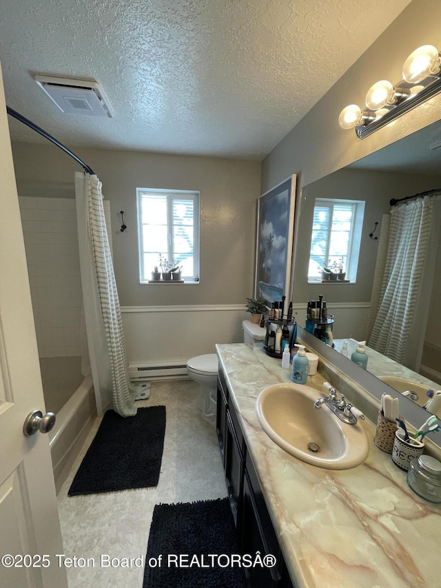 325 1st St N, Cokeville, WY 83114 - full bath with plenty of natural light, a baseboard heating unit, toilet, vanity, and a textured ceiling