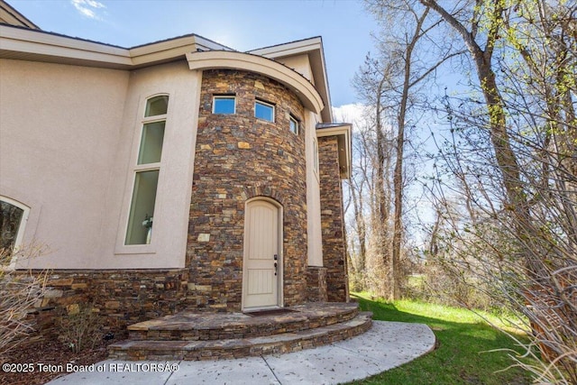 33 Willowbrook Dr, Driggs, ID 83422 - doorway to property with stone siding and stucco siding