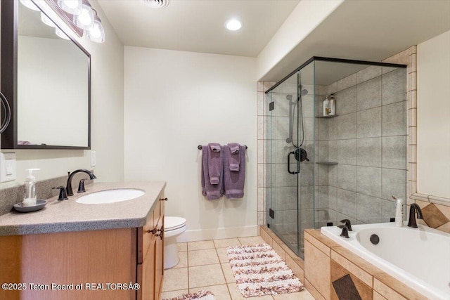 33 Willowbrook Dr, Driggs, ID 83422 - bathroom featuring tile patterned floors, a shower stall, a garden tub, vanity, and toilet