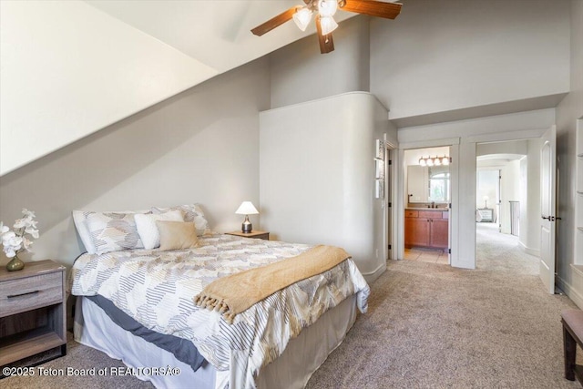 33 Willowbrook Dr, Driggs, ID 83422 - bedroom featuring light carpet, arched walkways, ensuite bath, baseboards, and ceiling fan