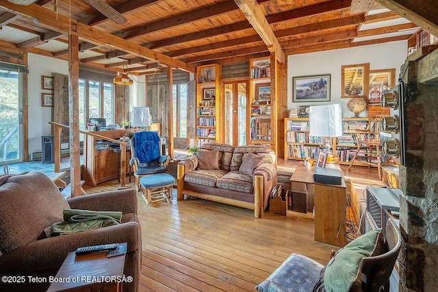 3837 County Road 126, Bedford, WY 83112 - living room with beamed ceiling, hardwood / wood-style floors, and a baseboard radiator