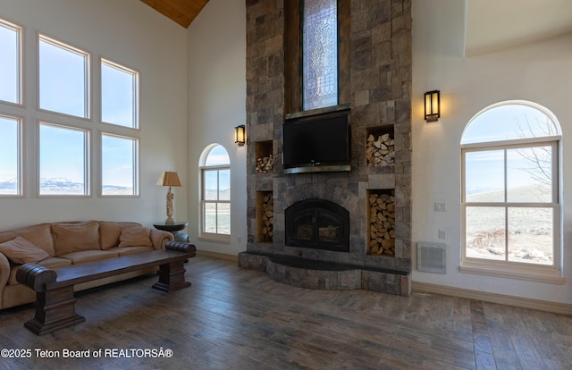 60 Flying Frog St, Dubois, WY 82513 - living room featuring hardwood / wood-style floors, a fireplace, baseboards, and high vaulted ceiling