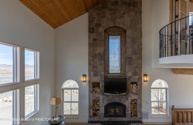 60 Flying Frog St, Dubois, WY 82513 - living room with high vaulted ceiling, a stone fireplace, and wooden ceiling