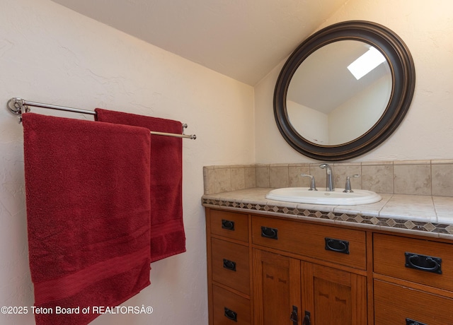 60 Flying Frog St, Dubois, WY 82513 - bathroom featuring vaulted ceiling and vanity
