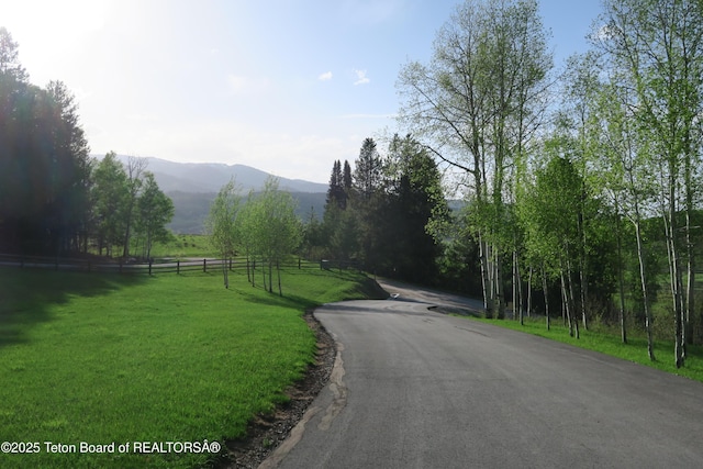 view of asphalt street with a mountain view