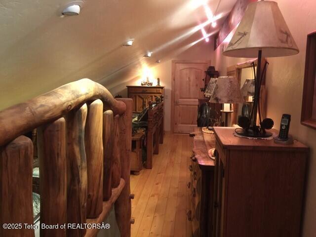 interior space with vaulted ceiling and light wood finished floors