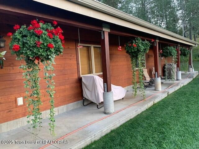 view of exterior entry featuring covered porch