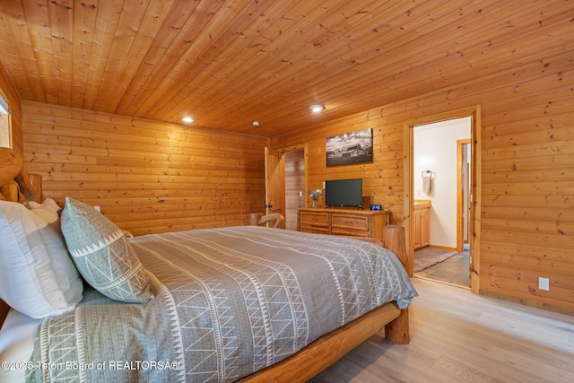 bedroom with light wood finished floors, wooden walls, wooden ceiling, recessed lighting, and connected bathroom