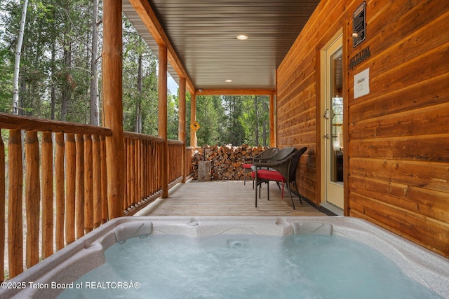 sunroom featuring a hot tub