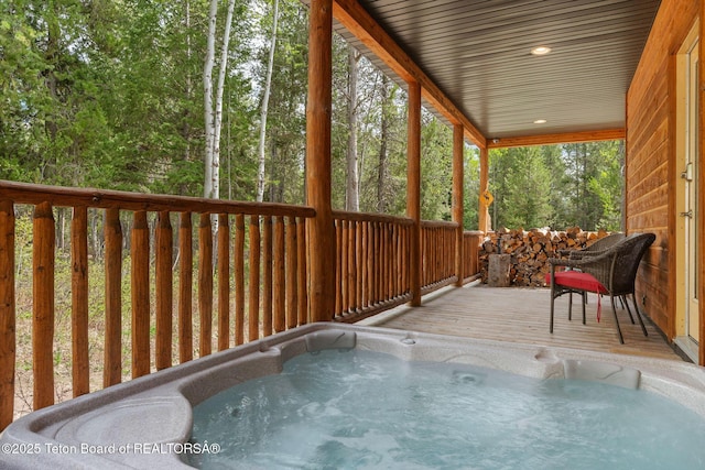 sunroom / solarium featuring a hot tub