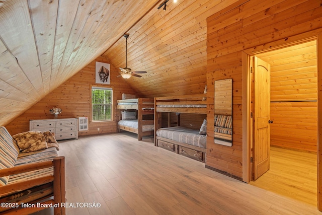 unfurnished bedroom with wood walls, hardwood / wood-style floors, lofted ceiling, and wood ceiling