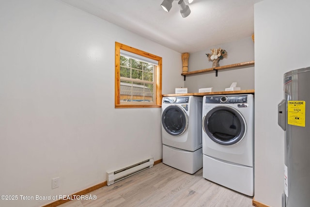 washroom featuring a baseboard heating unit, independent washer and dryer, light wood-style floors, water heater, and baseboards