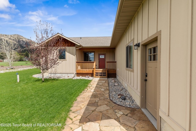 101 Alta Dr, Star Valley Ranch, WY 83127 - rear view of property featuring board and batten siding, a lawn, roof with shingles, and a mountain view
