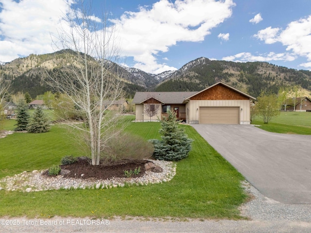 101 Alta Dr, Star Valley Ranch, WY 83127 - single story home with a mountain view, driveway, a garage, and a front lawn