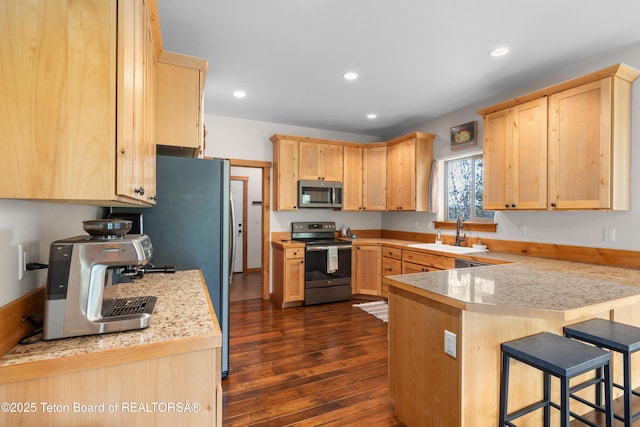 101 Alta Dr, Star Valley Ranch, WY 83127 - kitchen featuring stainless steel appliances, light brown cabinetry, a sink, a peninsula, and recessed lighting
