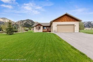 101 Alta Dr, Star Valley Ranch, WY 83127 - single story home featuring concrete driveway, a garage, a front yard, and a mountain view