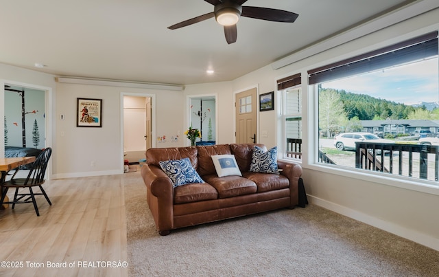 222 River Bench Rd, Alpine, WY 83128 - living area featuring a ceiling fan, baseboards, healthy amount of natural light, and light wood-type flooring