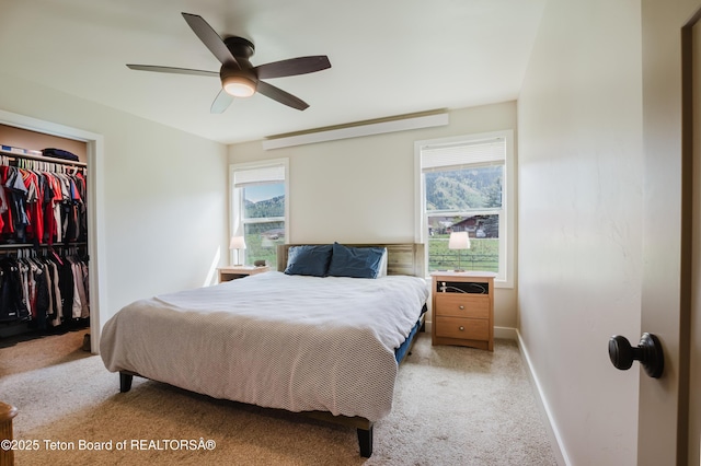 222 River Bench Rd, Alpine, WY 83128 - bedroom with light colored carpet, a closet, a walk in closet, baseboards, and ceiling fan