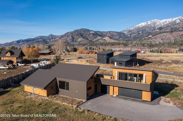 view of front of home with a mountain view, driveway, and a residential view