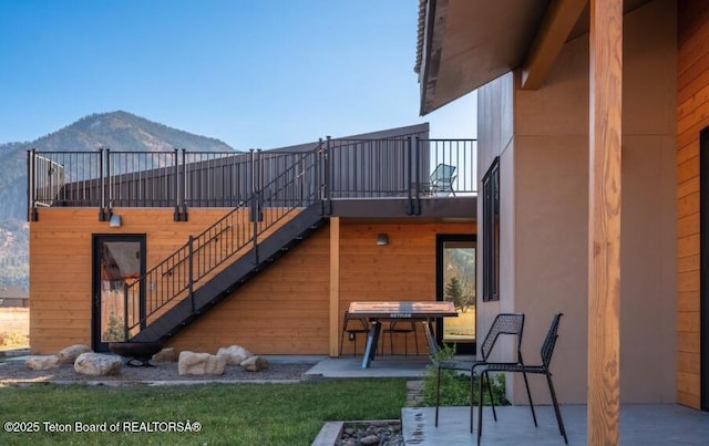 view of patio / terrace featuring a mountain view and stairway