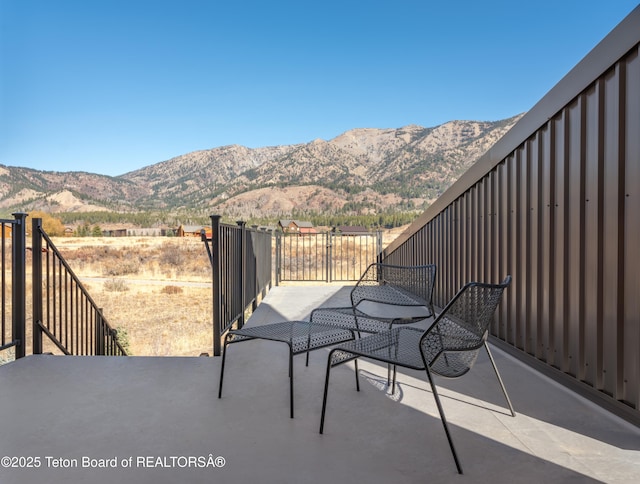 view of patio / terrace featuring a mountain view