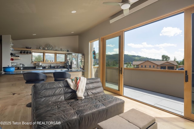 living area featuring healthy amount of natural light, a ceiling fan, wood finished floors, and recessed lighting