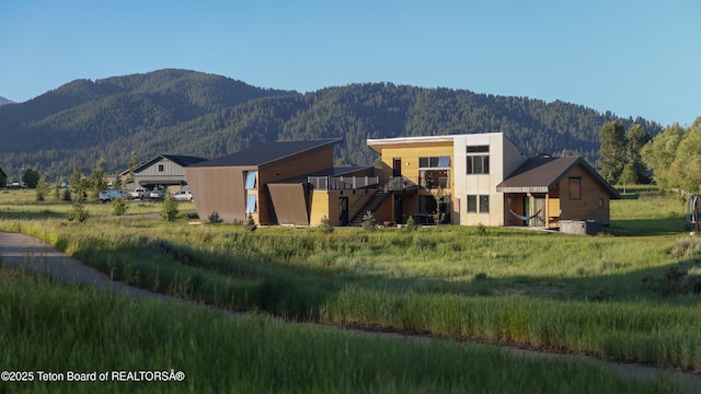back of property featuring a mountain view