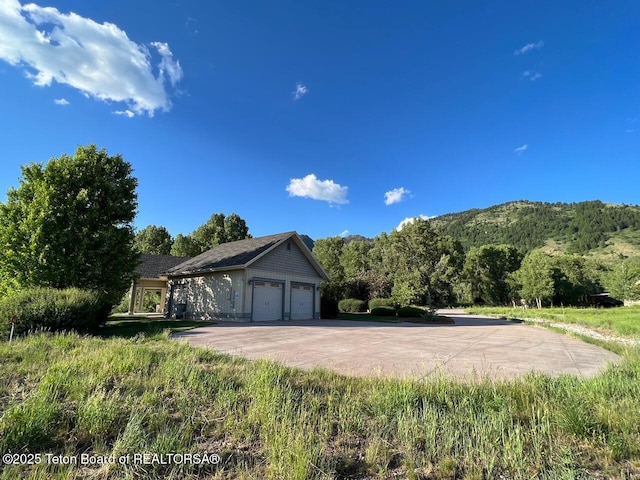 96 Hardman Rd, Star Valley Ranch, WY 83127 - view of property exterior with an attached garage and concrete driveway