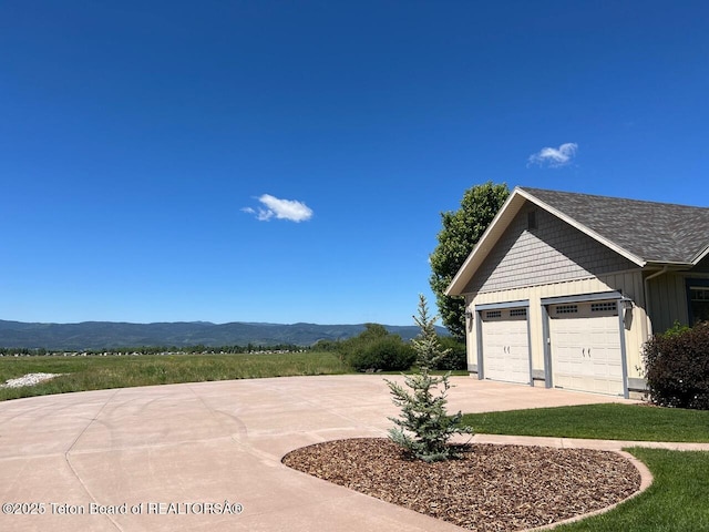 96 Hardman Rd, Star Valley Ranch, WY 83127 - garage featuring concrete driveway and a mountain view